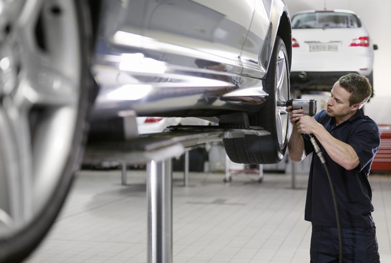 Summit-Financial-of-South-Carolina-mechanic-replacing-tire-on-car Auto Repairs & Services